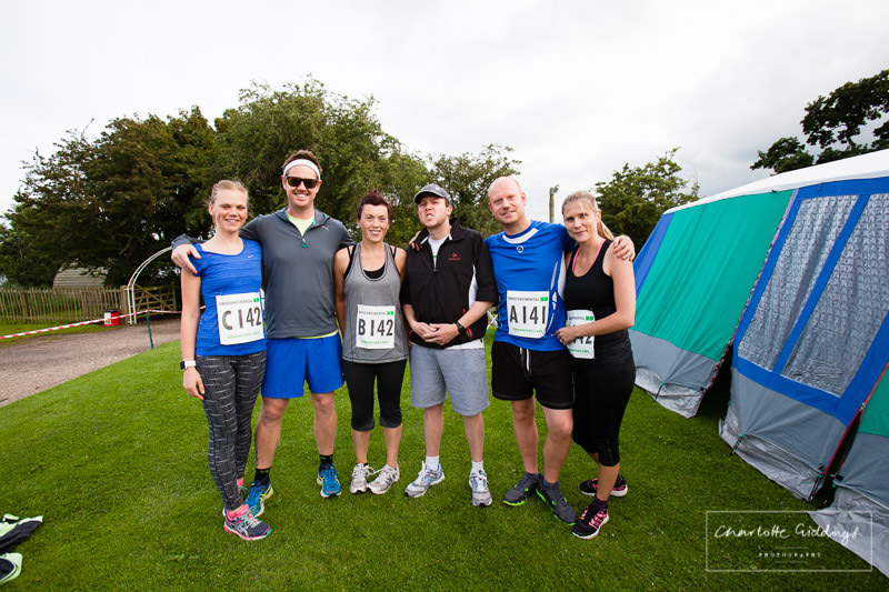 husband and wives teams group photo at dearnford lake before the race