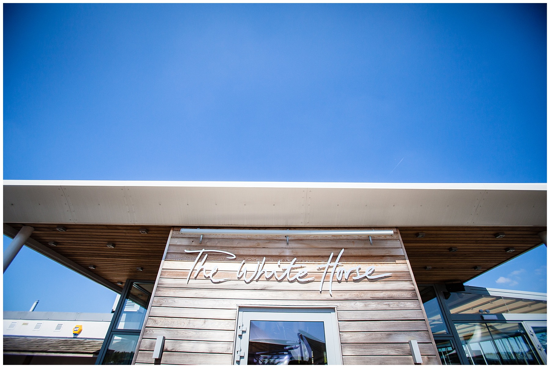 The white horse view of signage and blue sky - chester event photographer