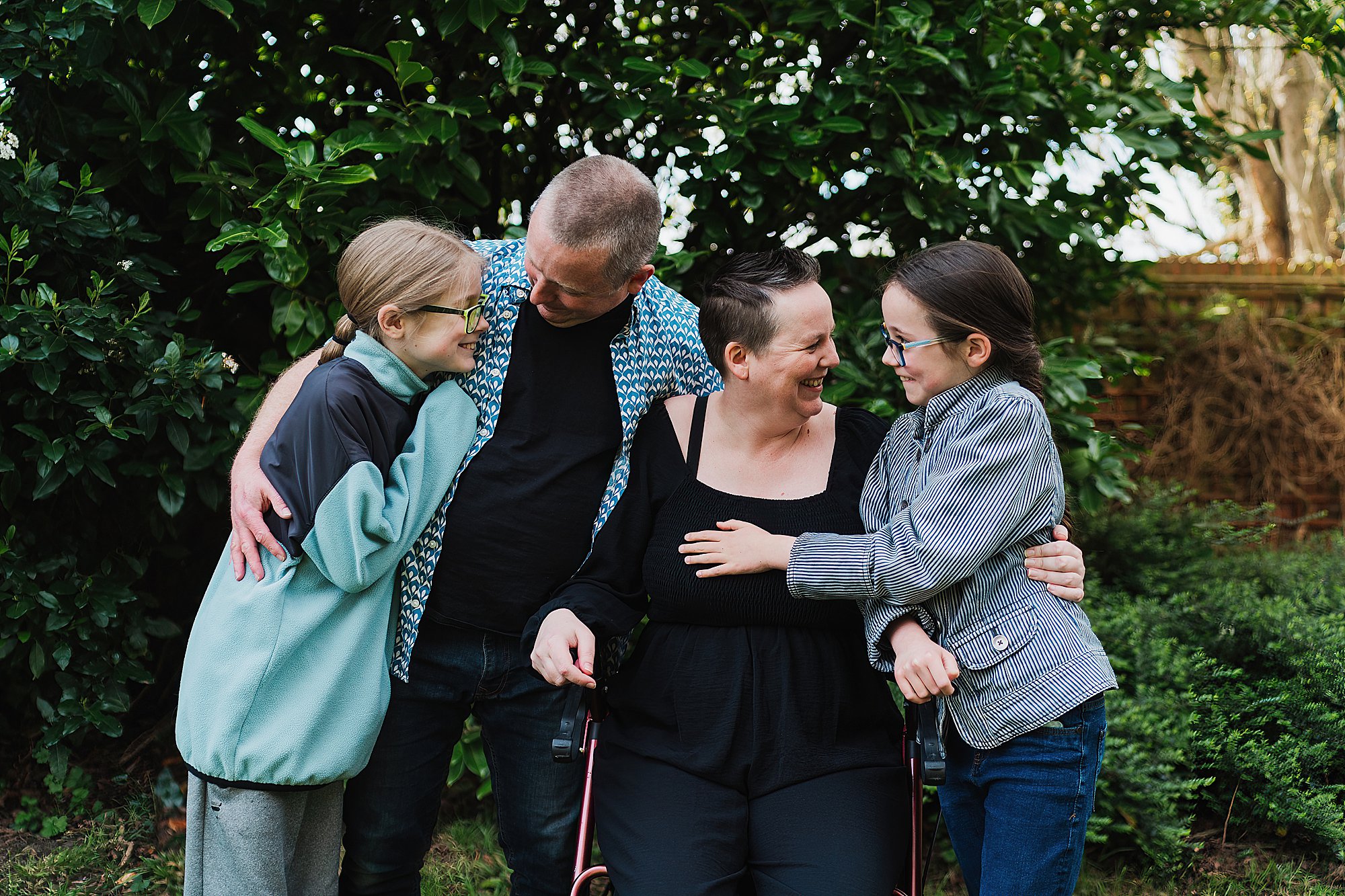 Family giggling between themselves in the garden in Shropshire // Charlotte Giddings Photography