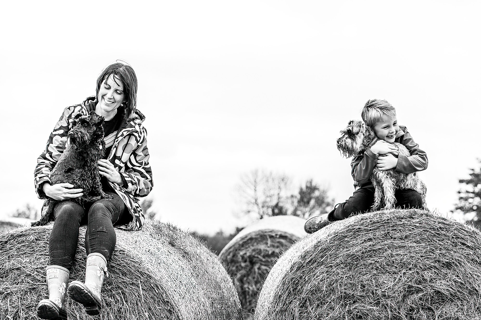 Mum and son sat on hay bales with their dogs in Whitchurch, Shropshire / Shropshire Family Photographer