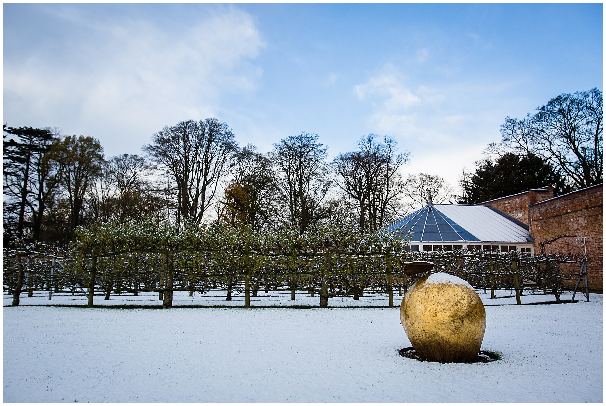 glasshouse in the snow with gold apple - Shropshire Wedding Venues in the Snow