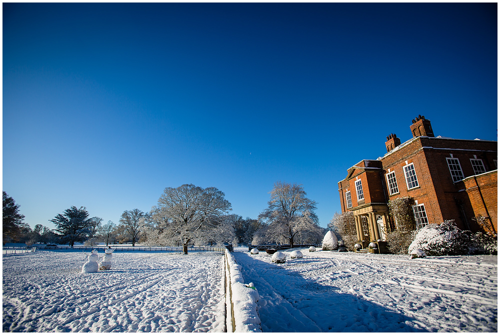 wide shot of shropshire wedding venue in the snow - charlotte giddings photography