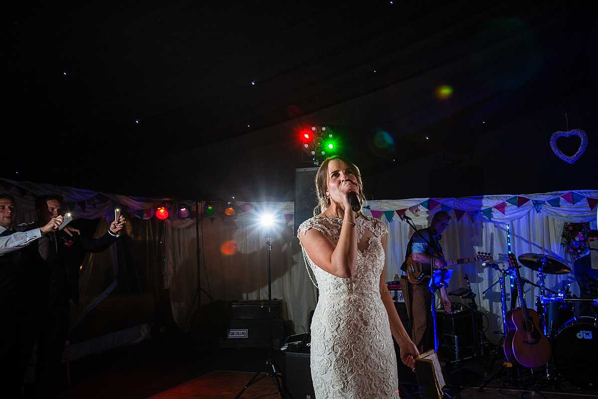 bride singing to the guests at her marquee wedding in Machynlleth, Wales