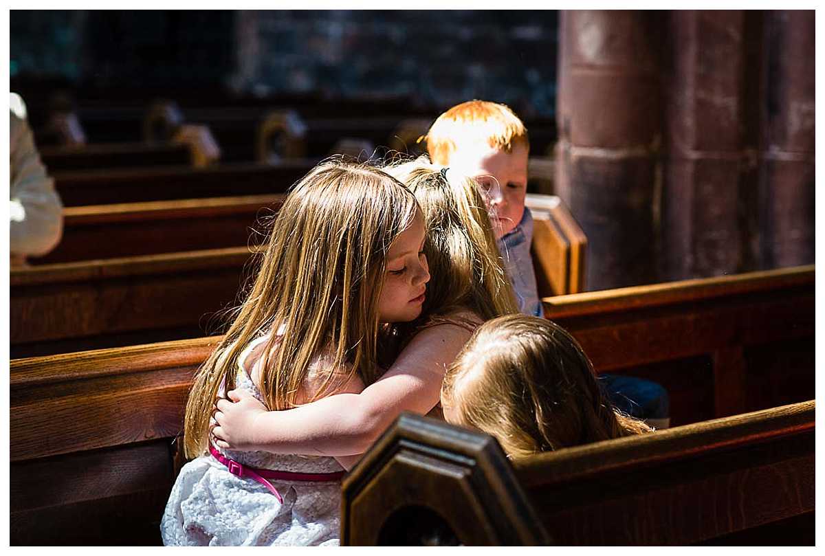 kids at the christening cuddling in church and looking very cute