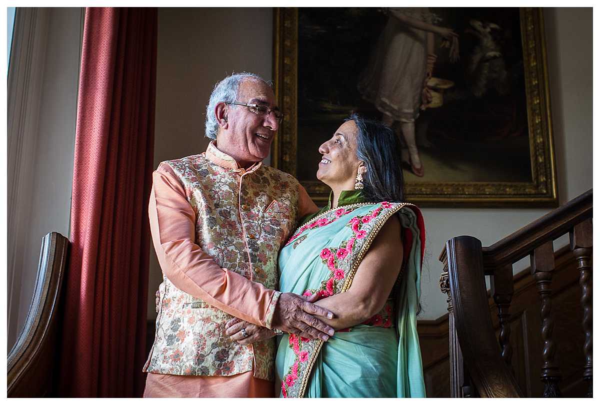 brides mum and dad in colourful indian dress in poundon house wedding venue