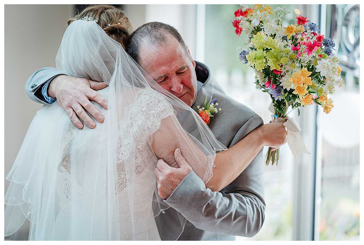 father of the bride emotional and giving his daughter a huge cuddle when he sees her ready in her wedding dress, wedding photographer shropshire