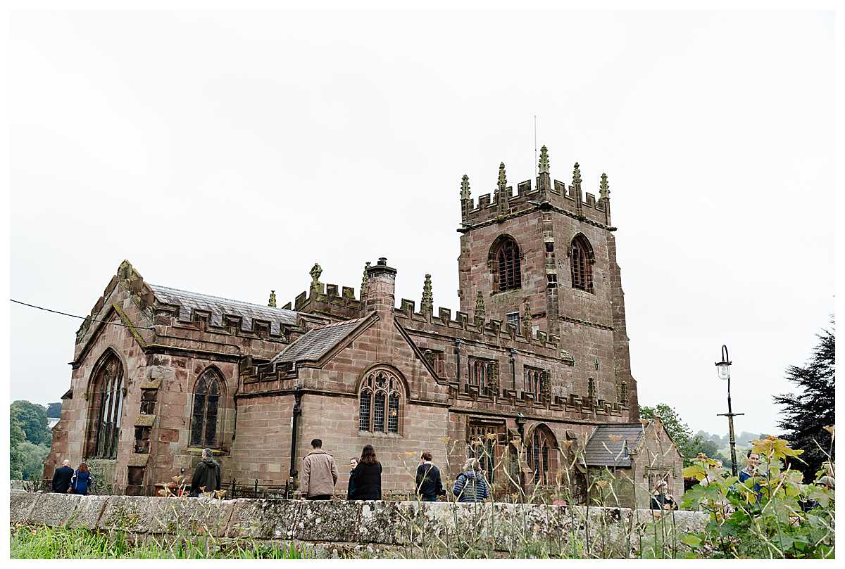 guests arriving at marbury church whitchurch shropshire on over cast day, shropshire wedding photography