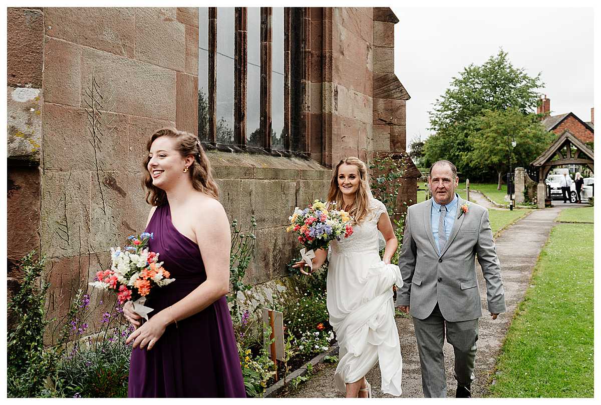 bride walking towards marbury church whitchurch shropshire - shropshire wedding photographer