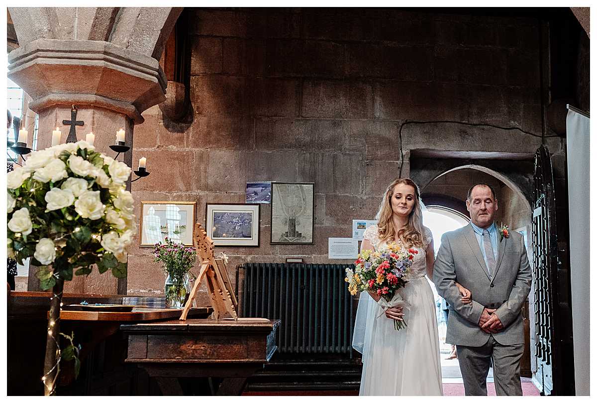 bride walking into marbury church, shropshire with her dad, charlotte giddings photography