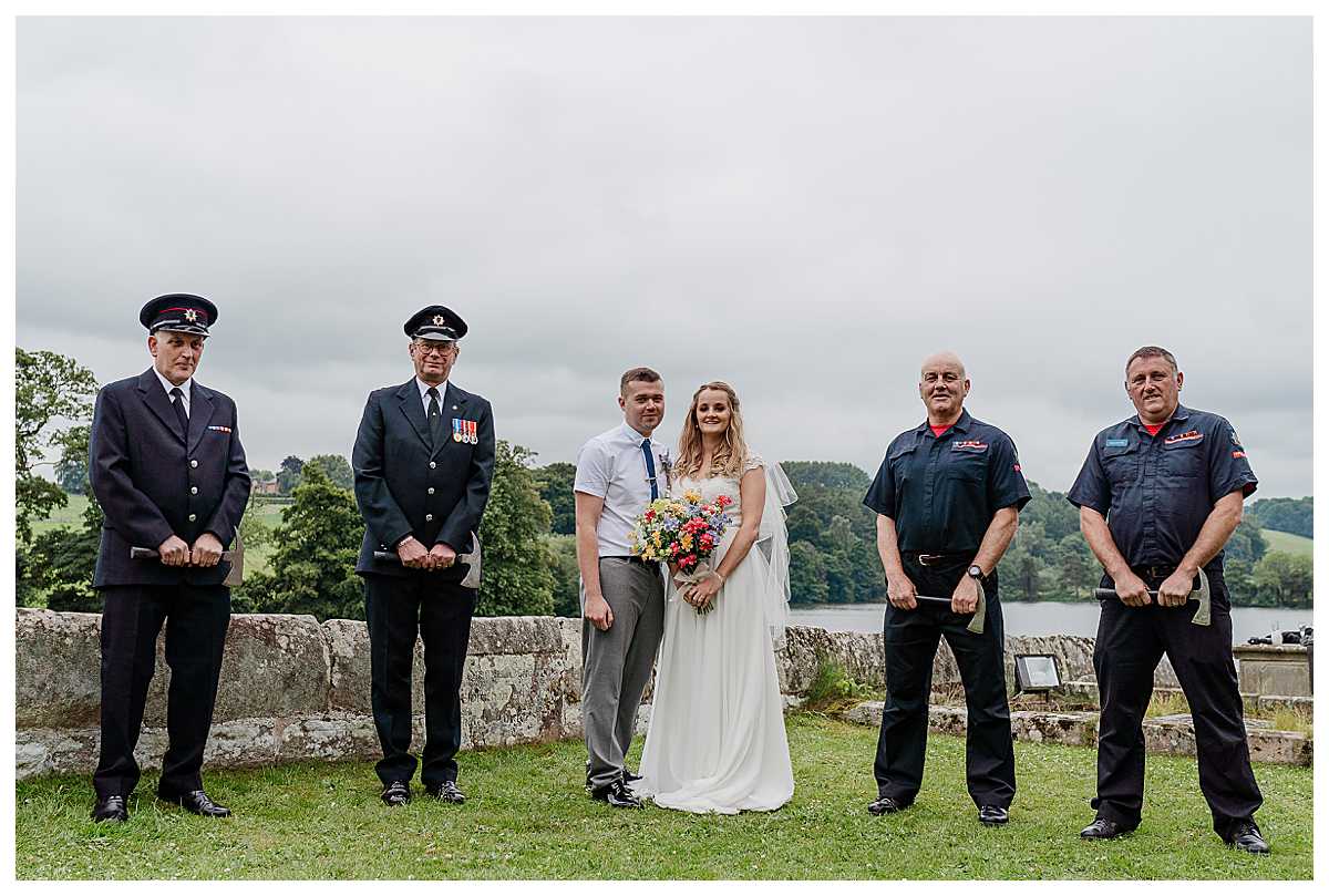 bride and groom with fire fighters at marbury church shropshire - wedding photographer shropshire
