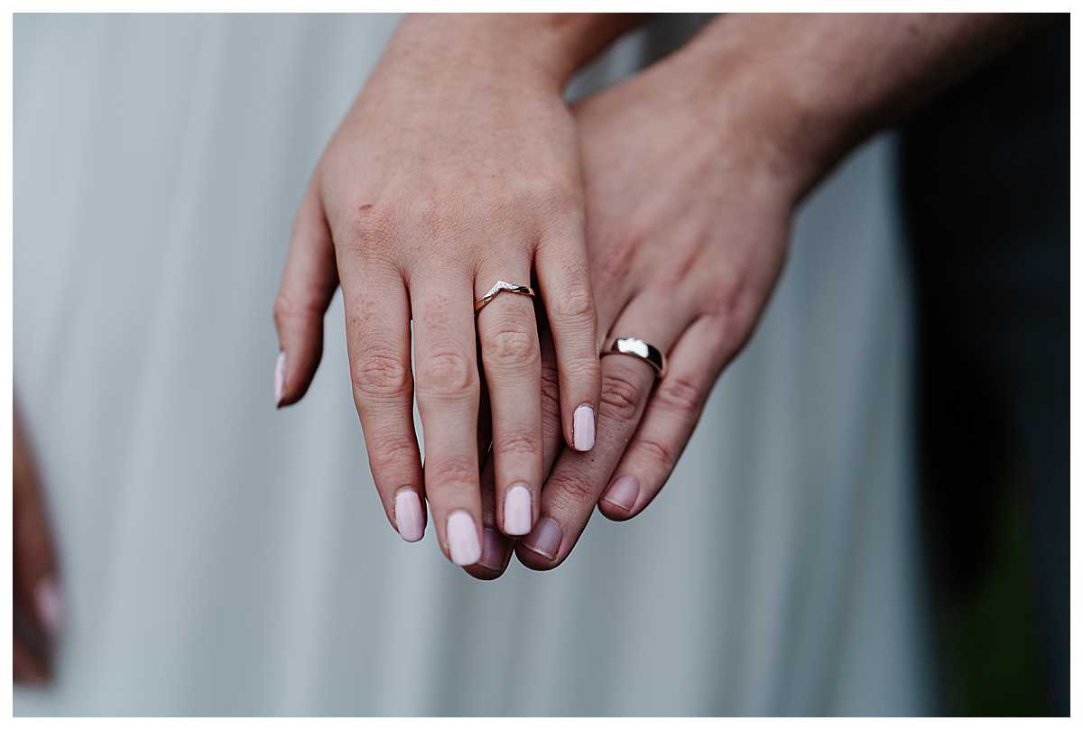 bride and grooms hands wearing wedding bands - shropshire wedding photographer