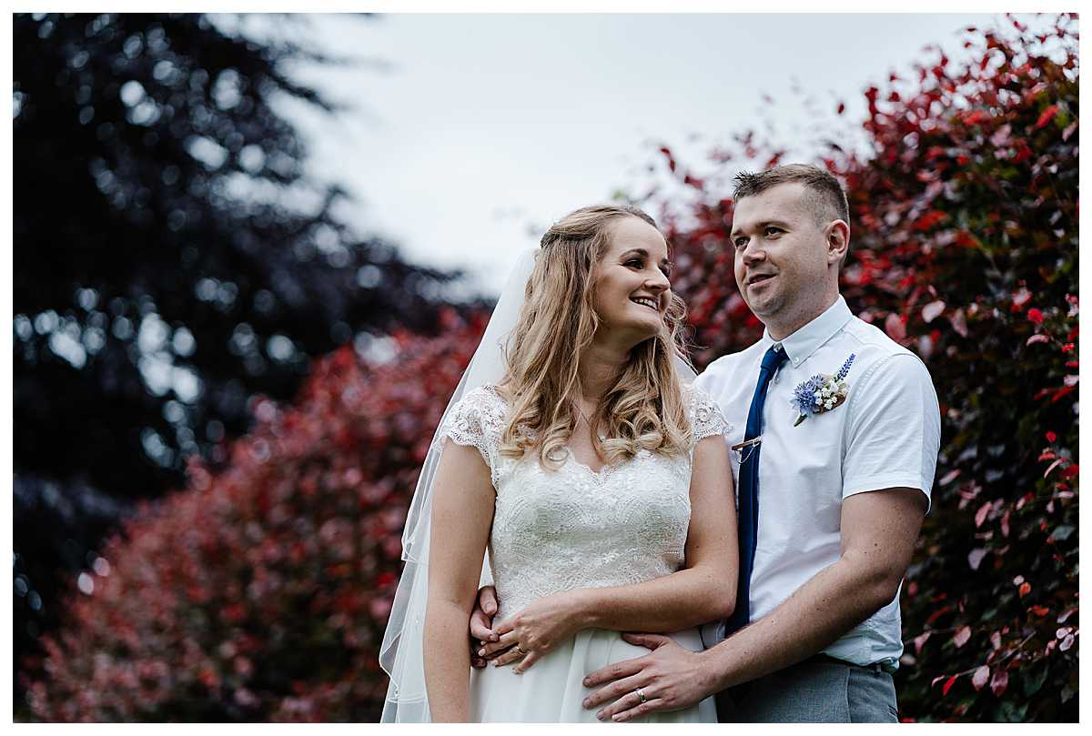 bride and groom giggling as they talk about their wedding at marbury church, whitchurch, shropshire