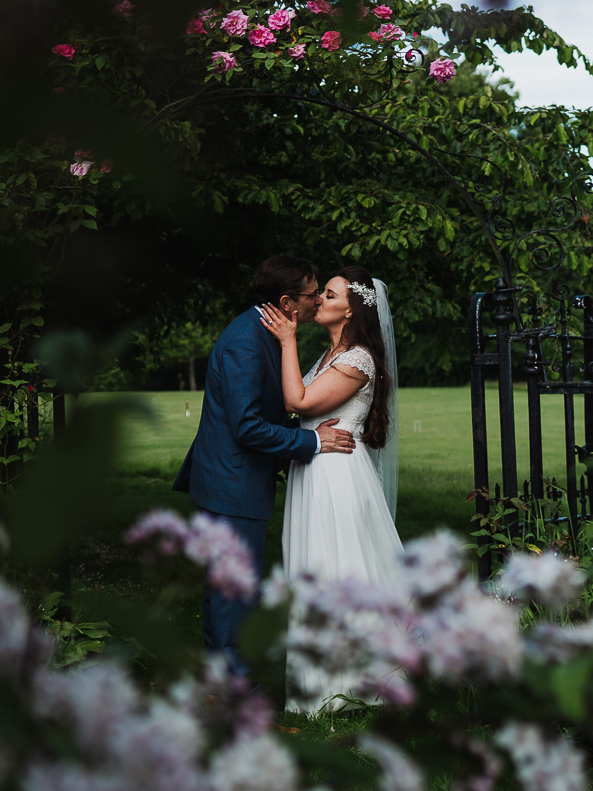 Dorfold Hall Wedding Photography Couple having a romantic kiss in the ground of Dorfold Hall, Cheshire, Charlotte Giddings Photography