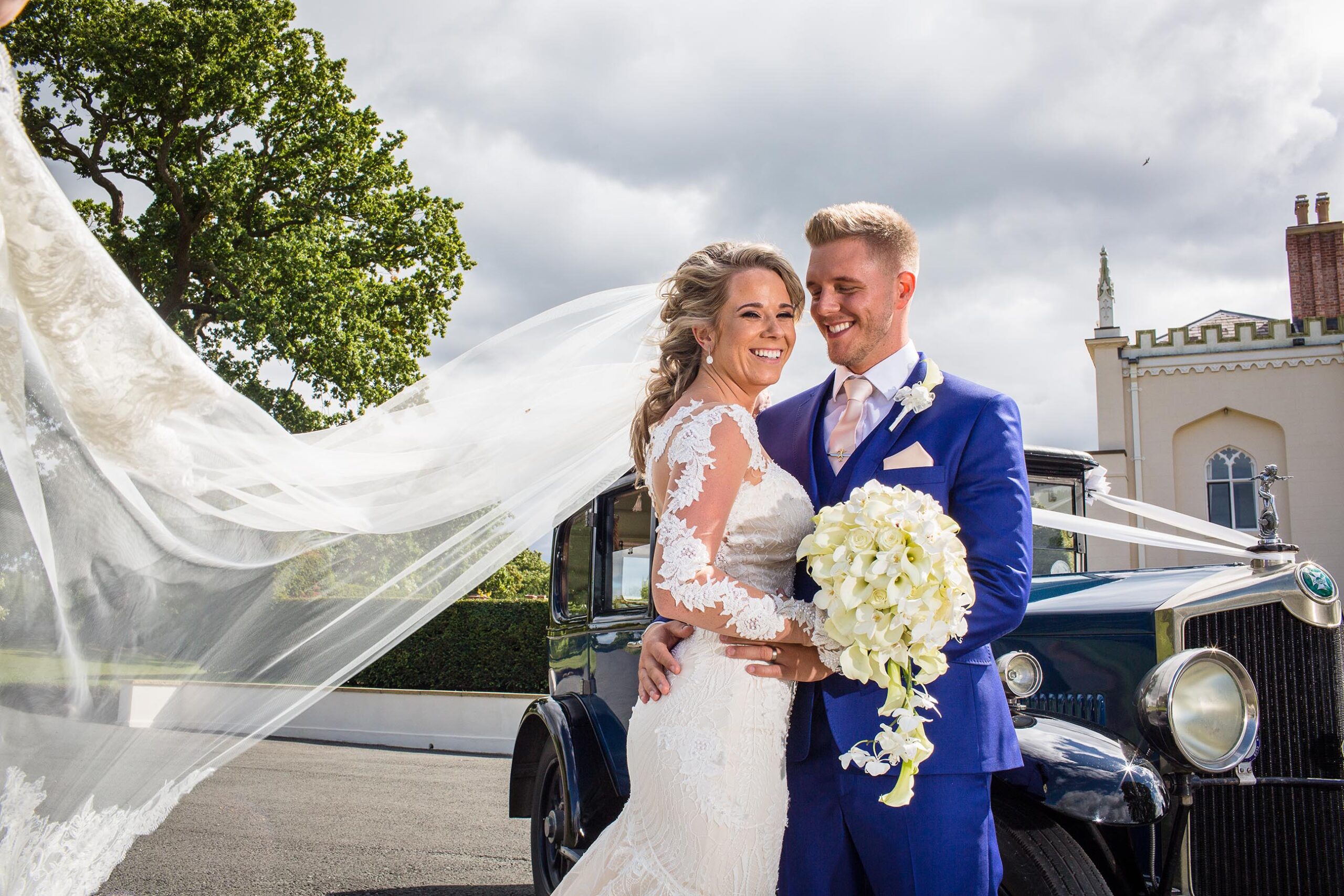 Bride and Groom with the Crossly Car outside Combermere Abbey