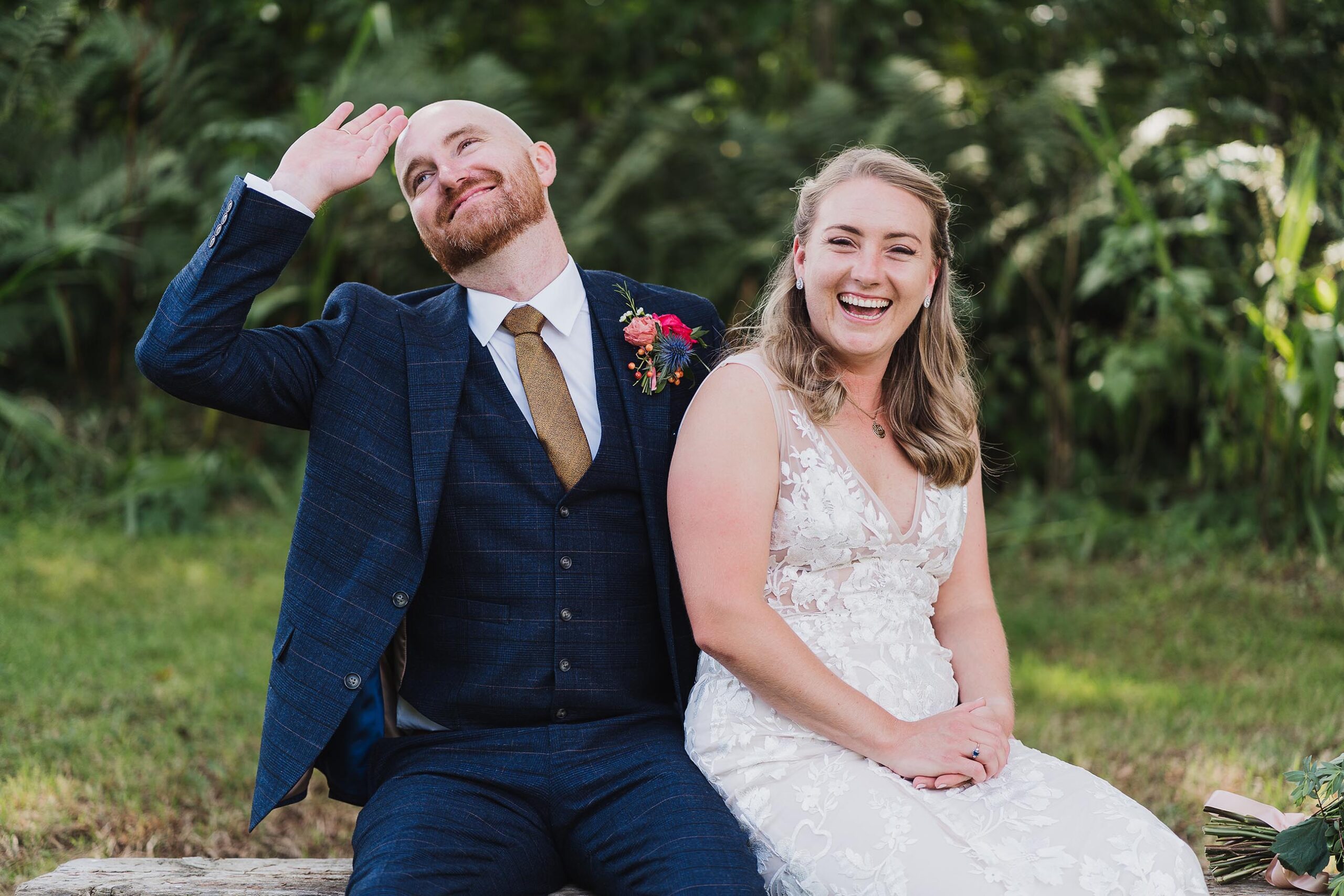 bride and groom mucking around at at home DIY Tipi wedding sat on a bendh, charlotte giddings photography
