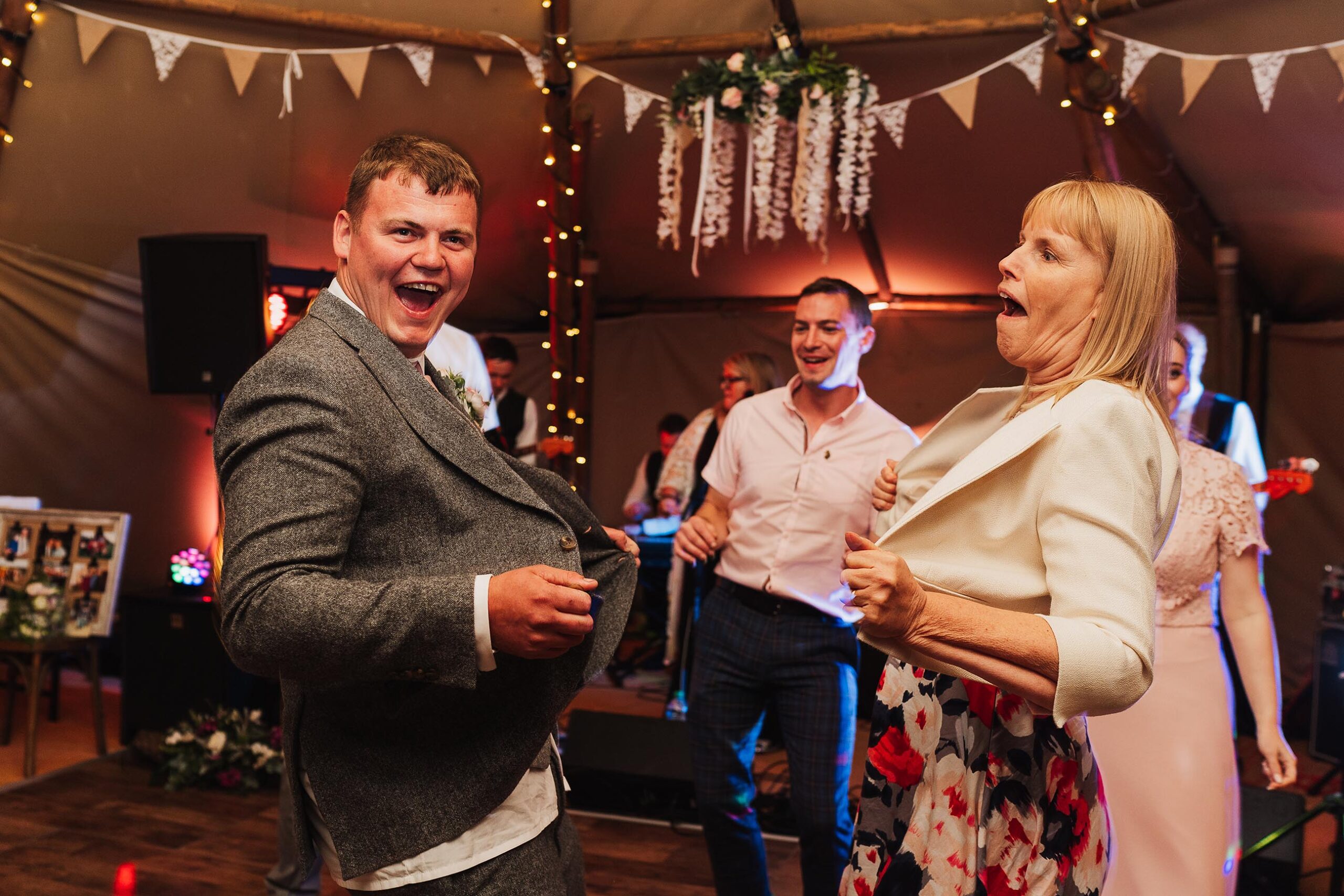 guests busting jackets open on the dancefloor, tipi wedding shropshire wedding photographer