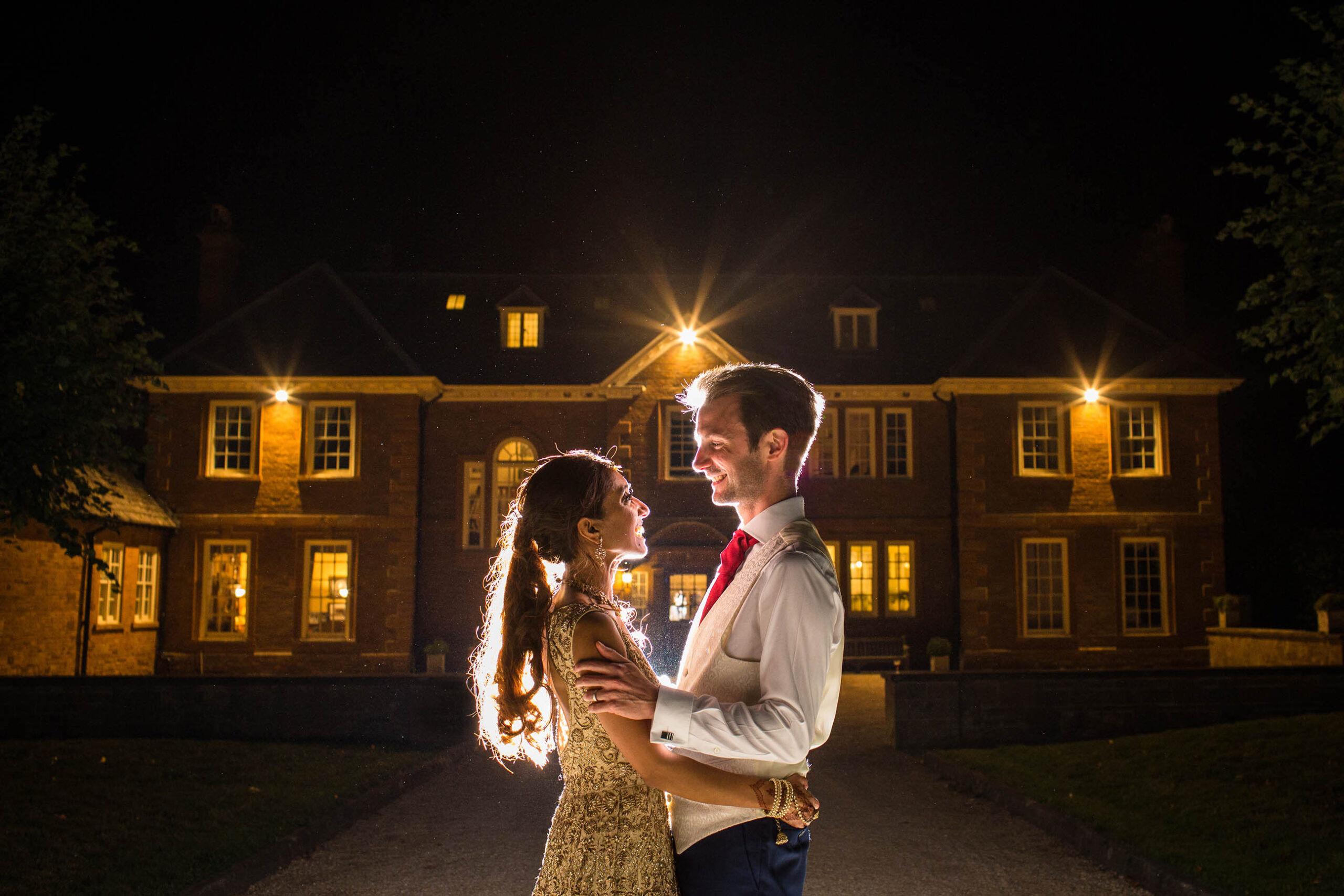 bride and groom in twilight looking at one another outside pounden house wedding venue