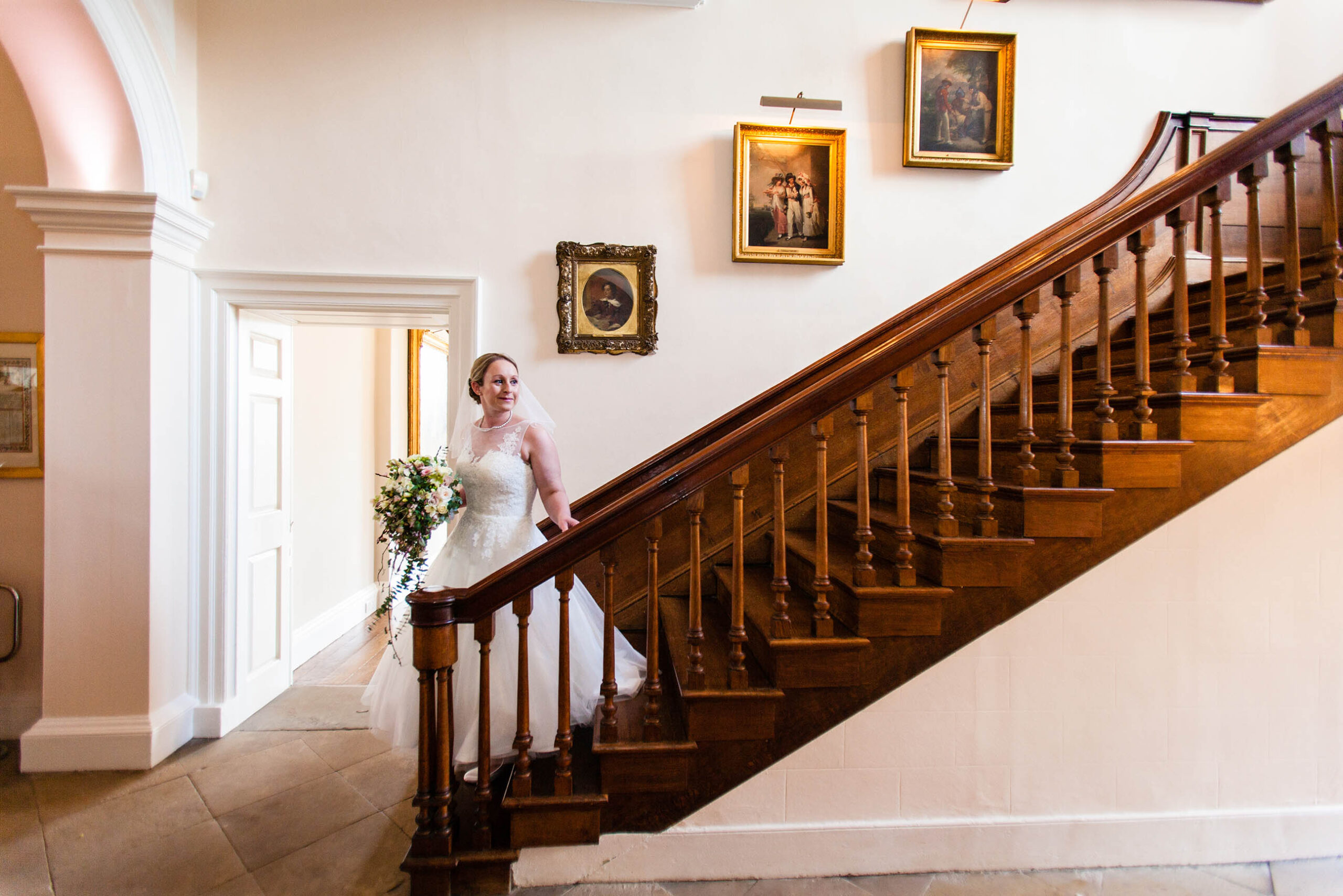 Bride walking down the stairs wedding ready at Iscoyd Park, iscoyd Park Wedding Photographer