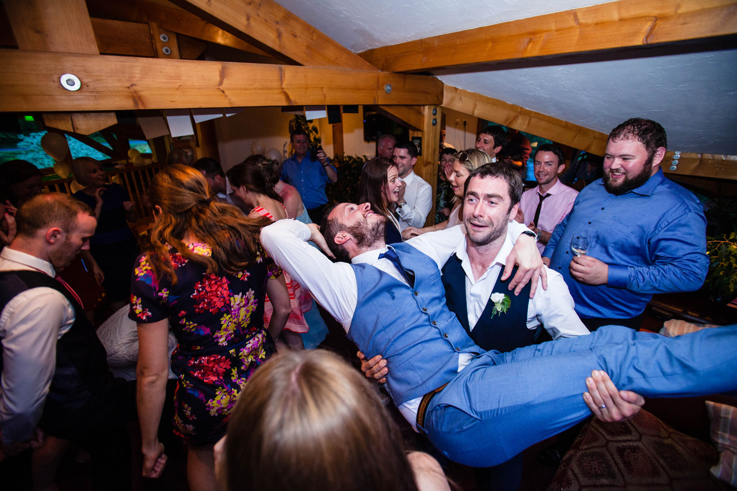 Groom being swung around on the dancefloor by friend at chalet in morzine wedding