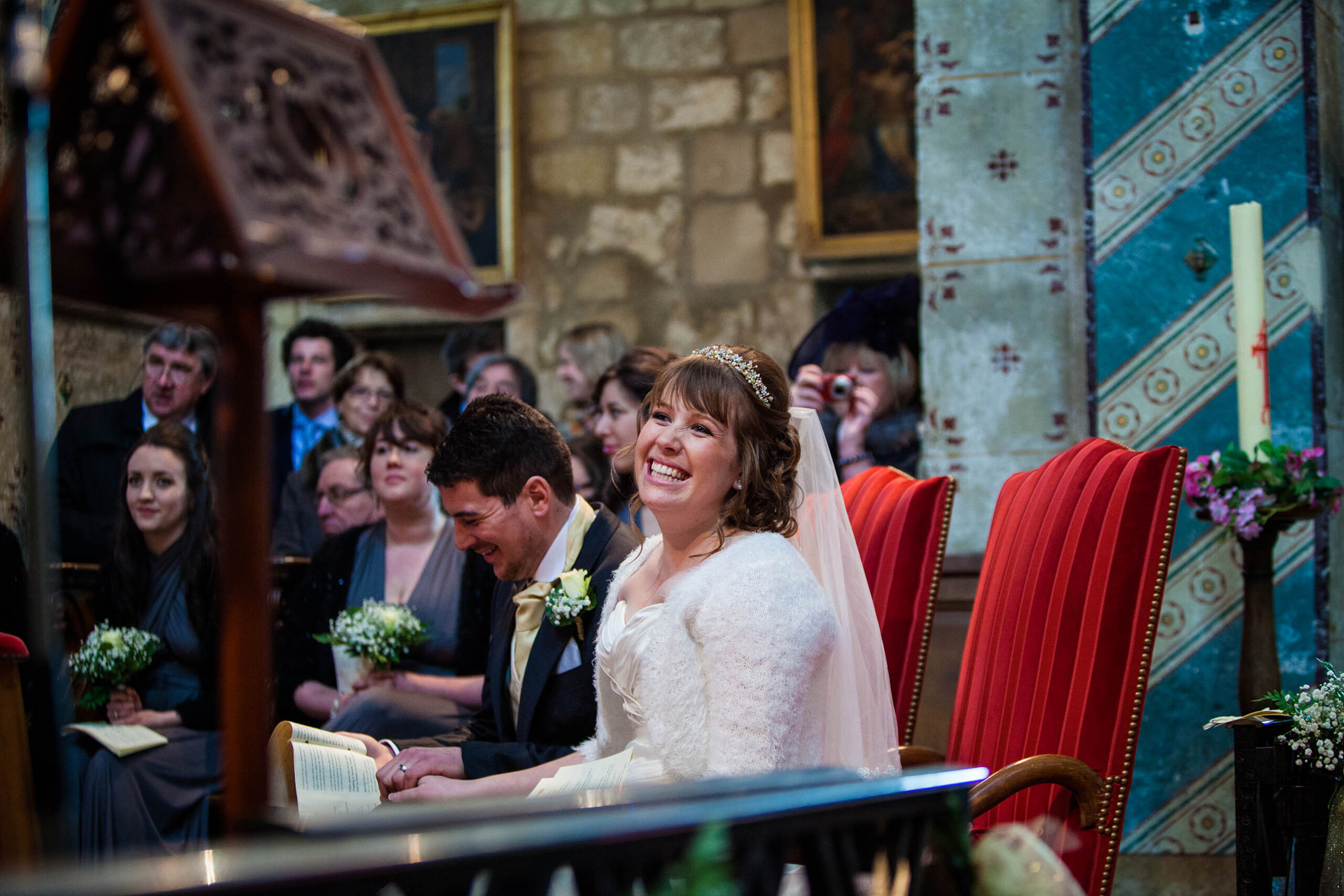Bride smiling ear to ear in wedding ceremony in Sacey, France, French Wedding Photographer