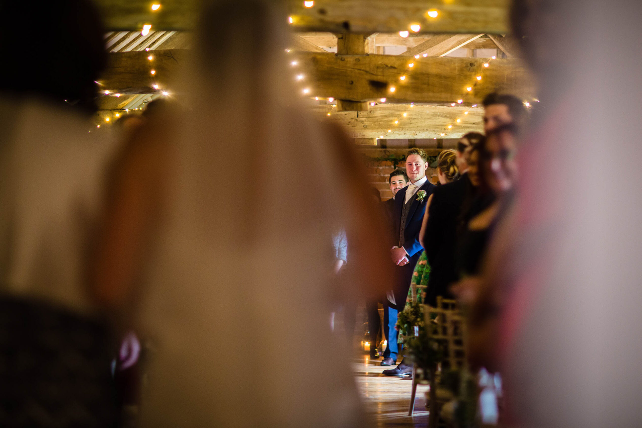 Grooms bitting his bottom lip as the bride is walking down the aisle at Soulton Hall, Shropshire