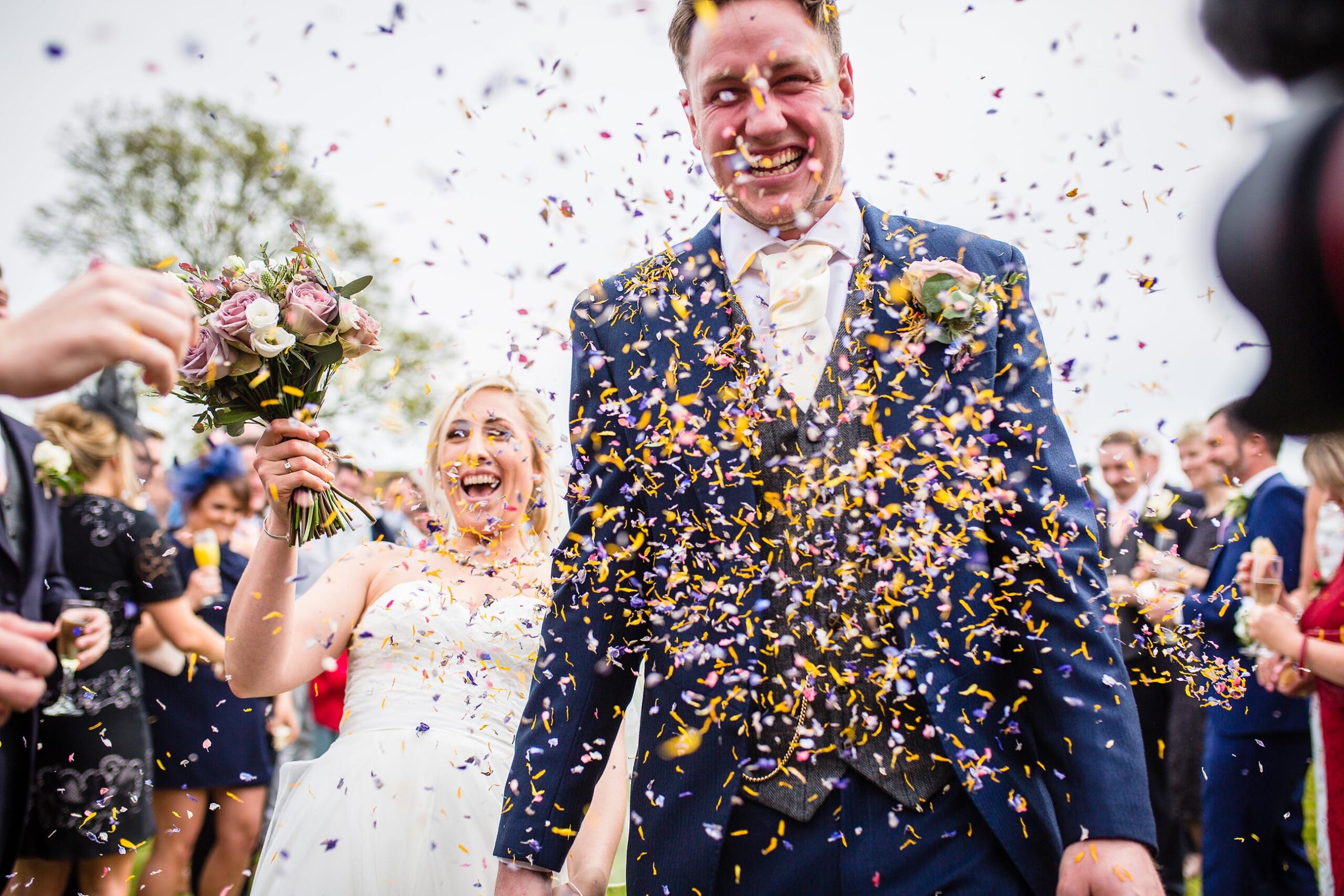 bride and groom saturated and fits of giggles doing confetti at Soulton Hall, Wedding Photographer Shropshire