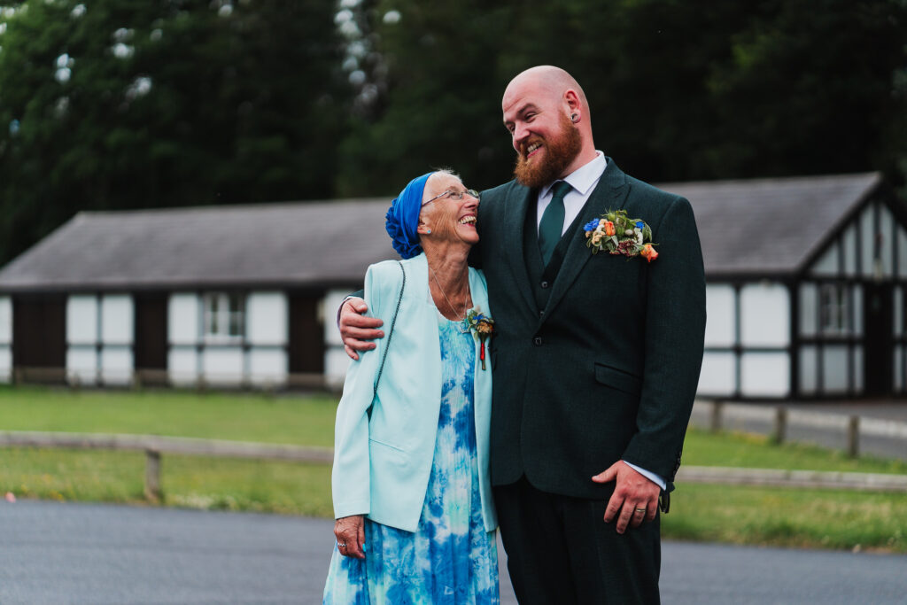 Groom cuddling with his nanna at Wistanstow Village Hall both looking as proud as punch / Charlotte Giddings Photography