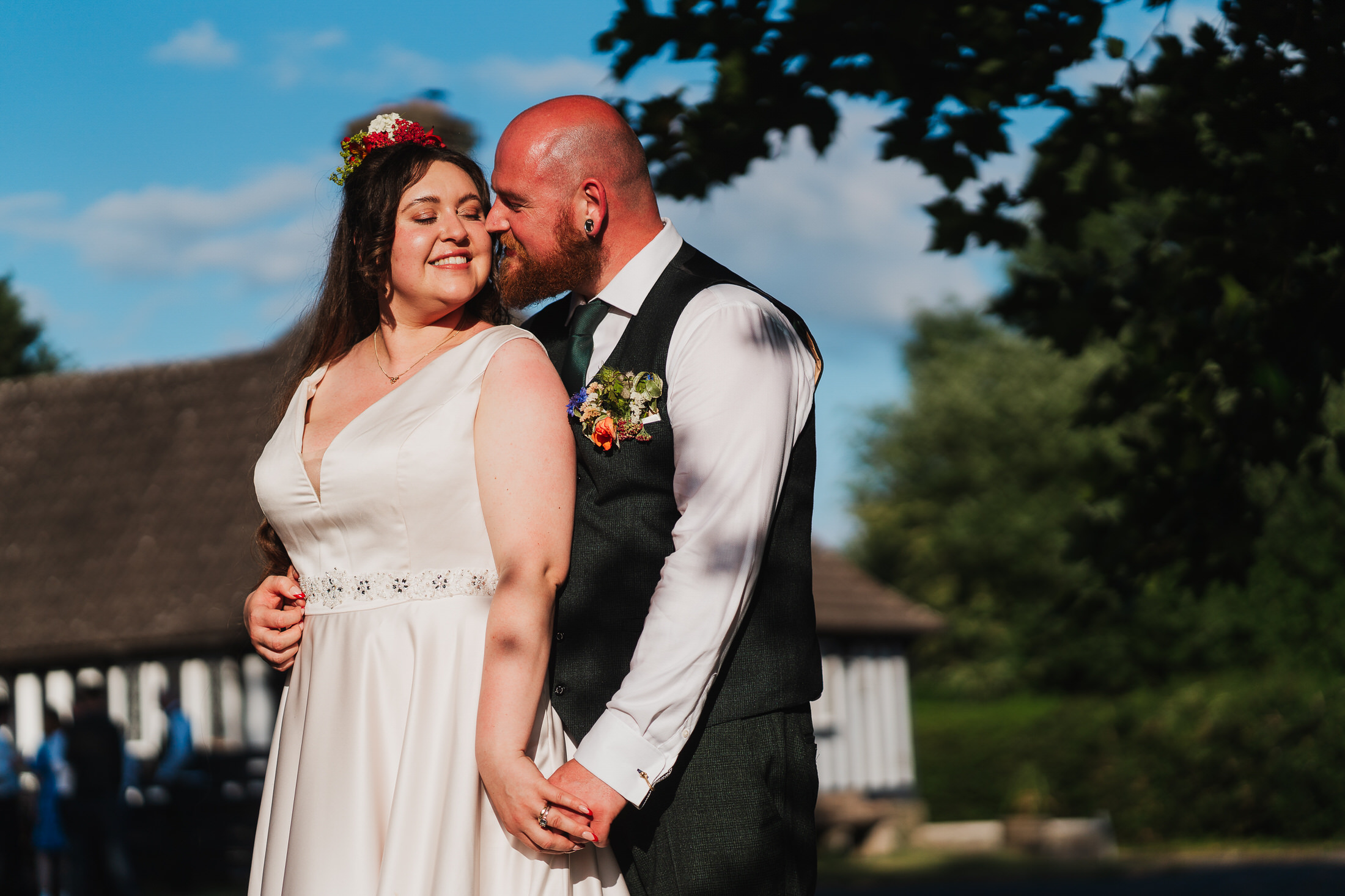 bride and groom standing in glourious sunshine at Wistanstow Village Hall, Craven Arms, Shropshire