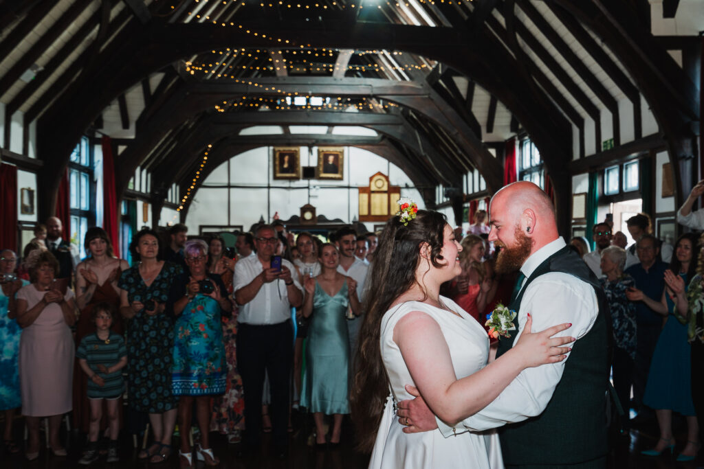 Bride and Groom performing their first dance in front of all their family and friends at Wistanstow Village Hall. Beautiful wooden beamed building

