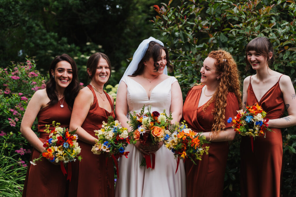 Bride with her four bridesmaids in their orange/brown themed dresses / Shropshire Wedding Photography
