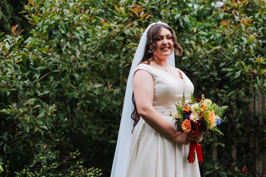 Bride excited to leave to go to church Holy Trinity Church, Wistanstow with her beautiful bouquet of flowers by Shropshire Flower Company