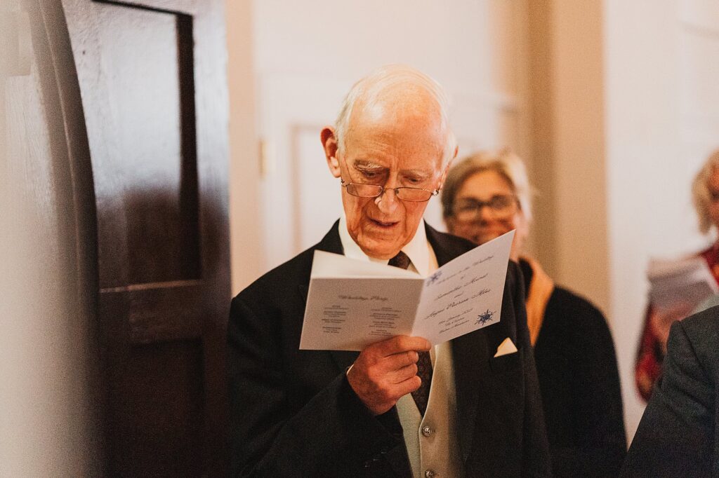Grandpa concentrating and singing "The Lighthouse' hymn in the ceremony at his grandson's wedding