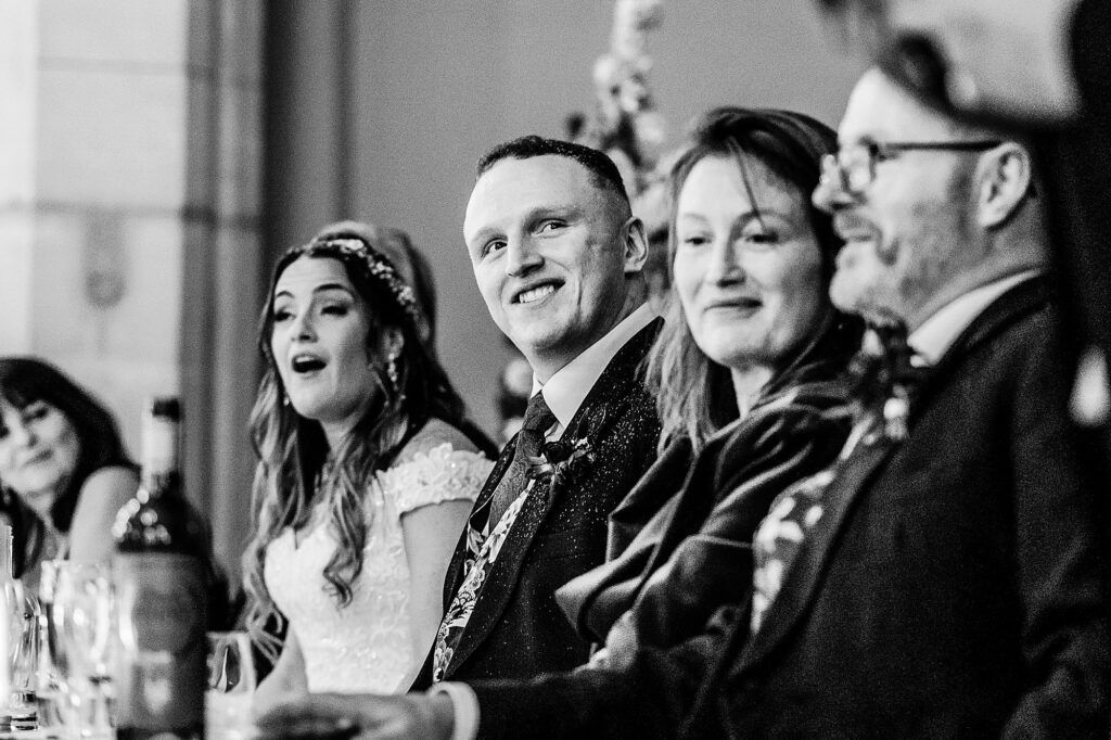 Groom looking lovingly at his brother doing a speech about him // Charlotte Giddings Photography