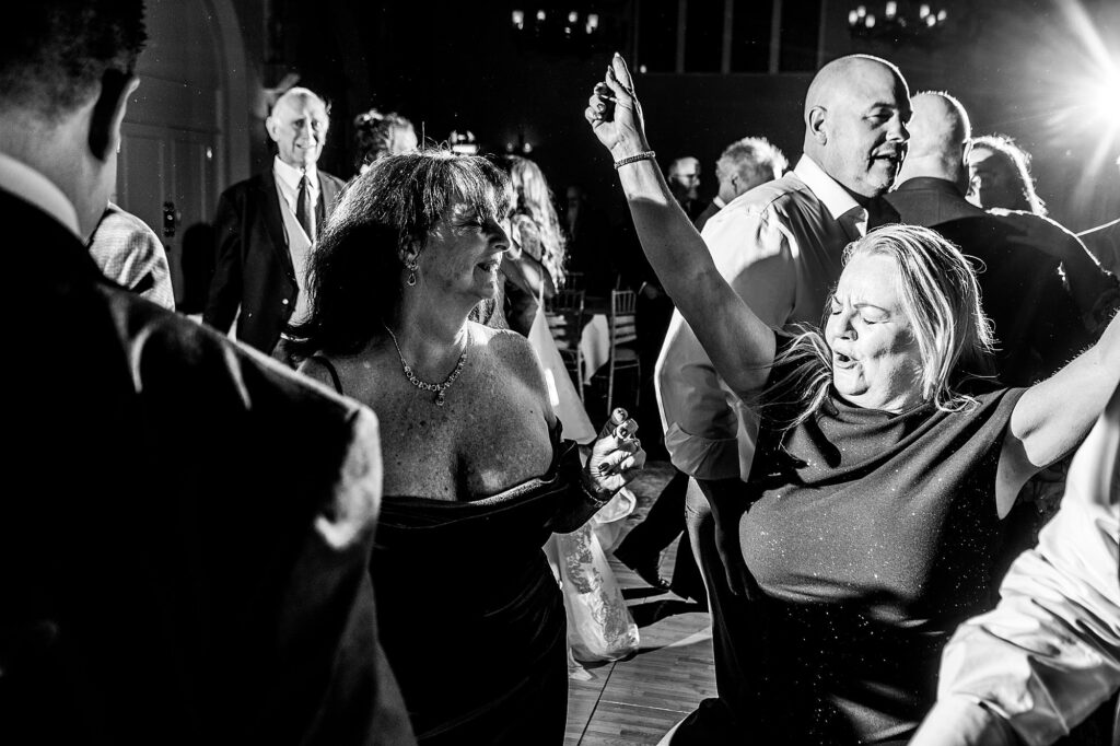Wedding guests enjoying themselves dancing to the DJ's mix at The Cloisters, Bolton