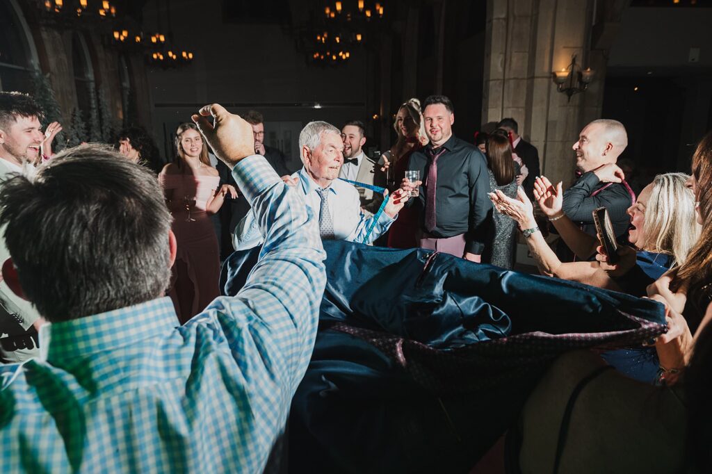 Bride's grandad having fun on the dancefloor and playing with is braces and removing his jacket! Charlotte Giddings Photography