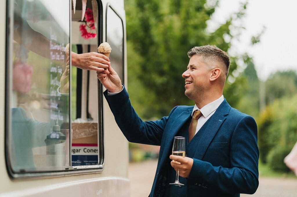 Man ordering an ice cream at a wedding at Iscoyd Park // Charlotte Giddings Photography // Shropshire Wedding Photographer