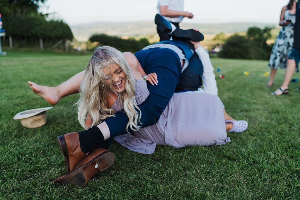 Wedding guests have a big pile on at a DIY wedding in the summer in South Shropshire // Shropshire Wedding Photography
