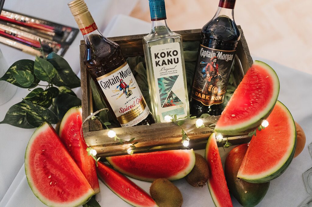 Display of a variety of rums for guests to make their own cocktails at a Combermere Abbey Wedding