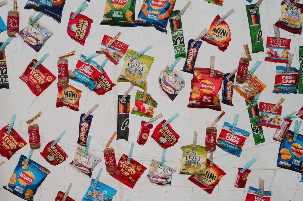Display of snack for wedding guests to help themselves at a DIY wedding ranging from chocolate bars, biscuits, and retro crisps // Angelsey Wedding
