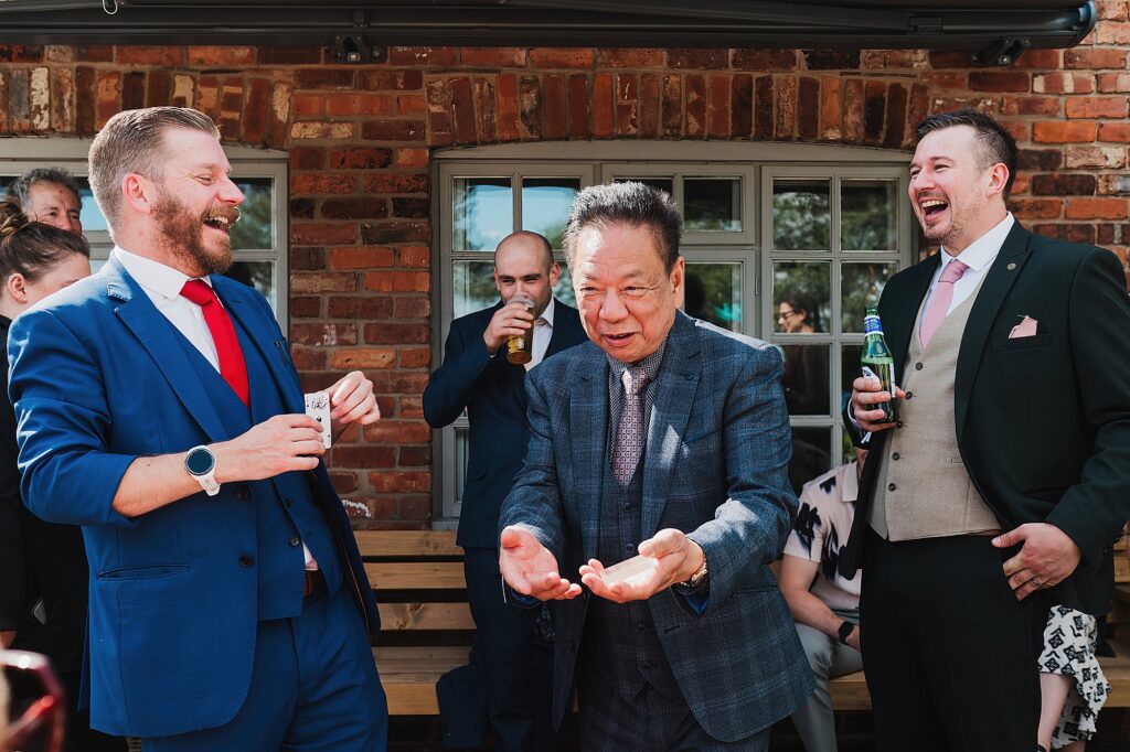 Nick Marshall performing a magic trick on the father of the bride and he is left flabbergasted and guests laughing out loud at Larkspur Lodge, Cheshire