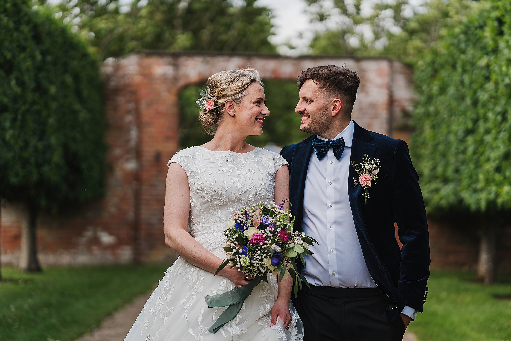Charlotte Giddings Photography Shropshire Wediding Photographer_0267 Beautiful couple on their wedding day walking from the walled gardens of Combermere Abbey, Wedding Venue Shropshire