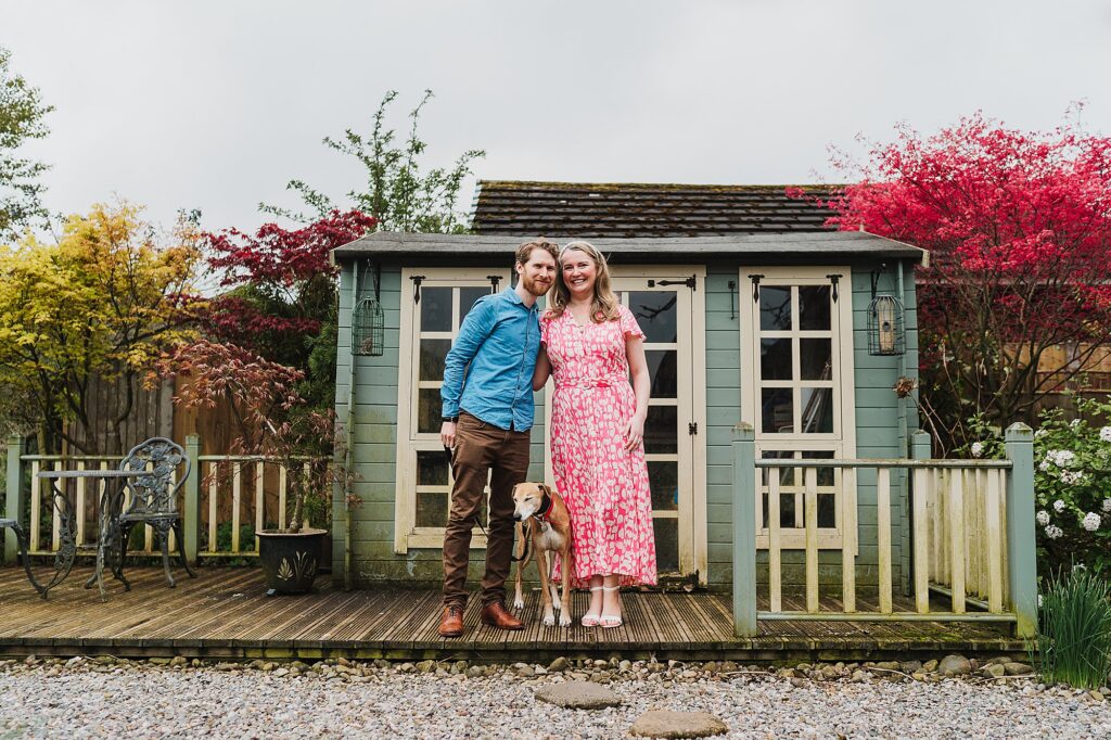Bride and Groom with their dog outside the summer house in the garden // Shropshie Pre Wedding Shoot