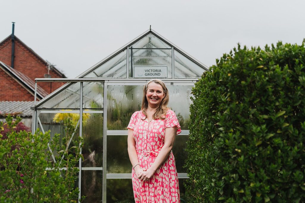 Bride to be looking very excited with the thought of getting married in a couple of months and standing for a portrait in the garden amongst the blooms