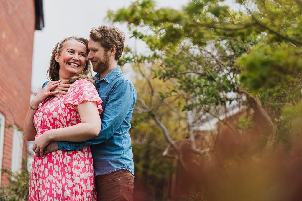 Bride and Groom looking at each other cuddling in the garden on a summers day // Wedding Photographer Shropshire