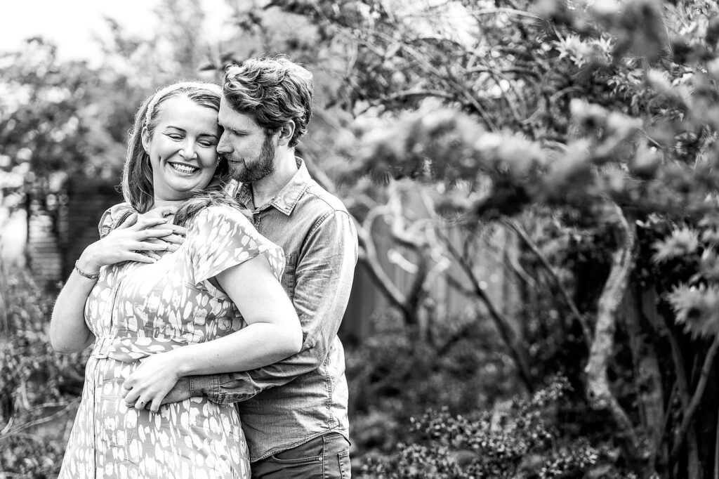 Bride and Groom to be cuddling in the garden and whispering sweet nothings to themselves // Combermere Bride 2023