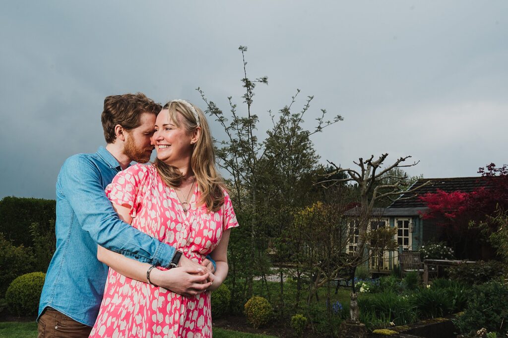 Bride and Groom to be spooning and cuddling in the garden in Shropshire // Wedding Photographer Shropshire