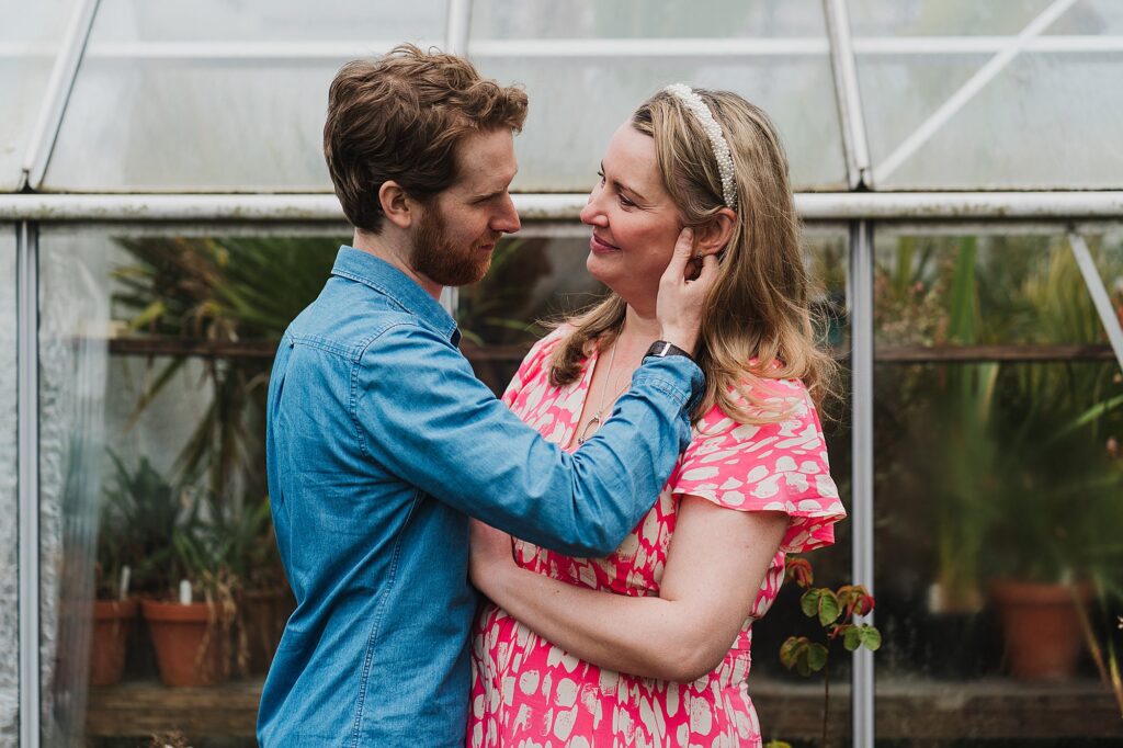 Groom to be romantically running his hand down the side of his bride to be's face // Pre wedding shoot Shropshire