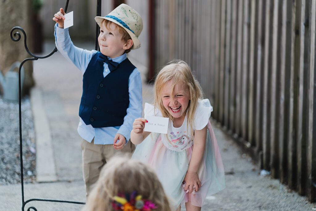 Little girl giggling at a label she has "gin and tonic" // Cheshire Wedding Photography