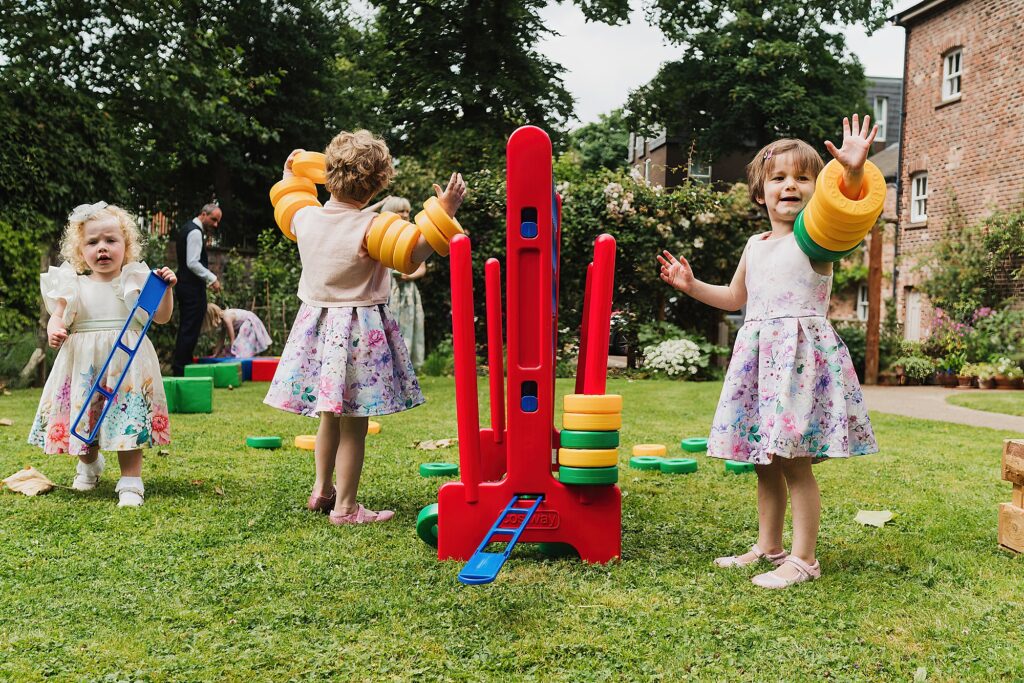 Little girls playing with the connect four circles running up their arms rather than playing games! Charlotte Giddings Photographer