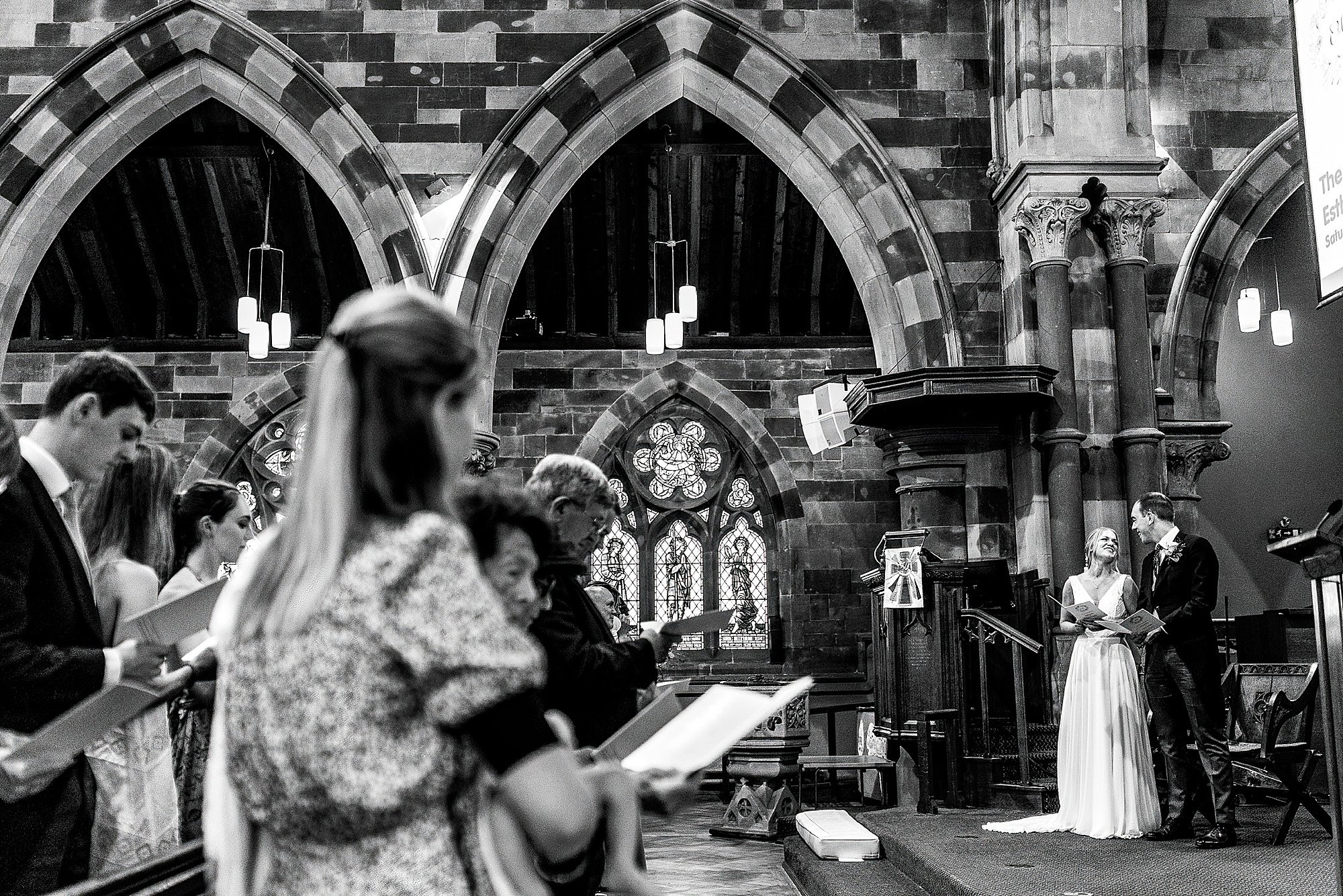 Communication with Photographer 00021 Bride and Groom singing hymns in church having a moment together giggling, Shrewsbury Wedding Photographer